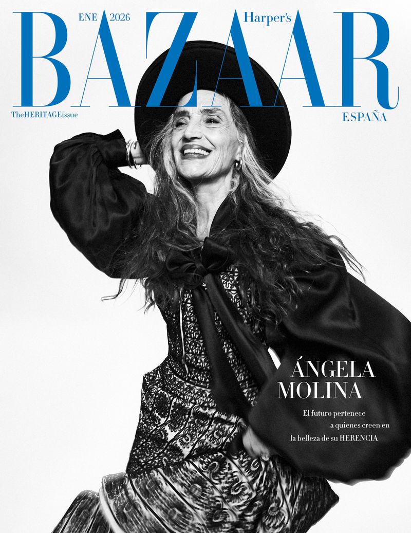 Magazine cover featuring an older woman with long gray hair wearing a black hat and lace dress, smiling against a light background.