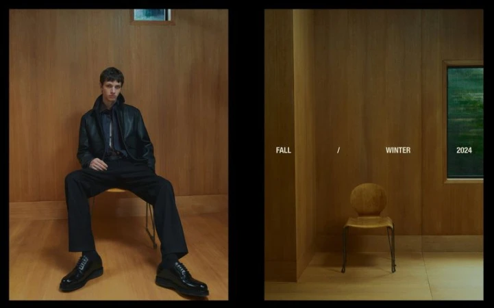 A man in a leather jacket and trousers sits on a chair against a paneled wall in a fashion editorial. Neutral tones with a seasonal campaign.