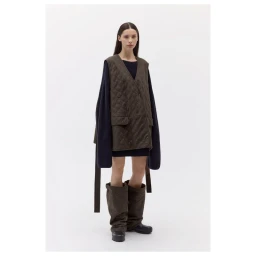 Model wearing a brown quilted vest and dark sweater against a plain white background for ICICLE Natural Way Capsule collection