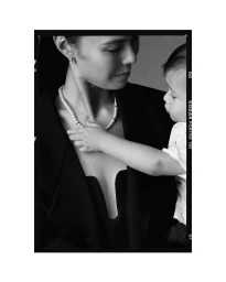 Black and white portrait of a woman wearing a pearl necklace with a child touching the pearls for the She's Extraordinary project by Kennedy.