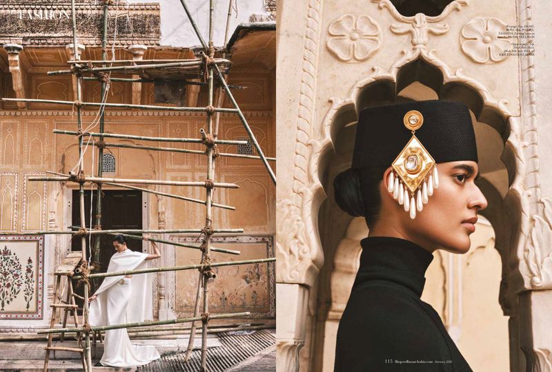 Fashion editorial featuring a model in traditional clothing and jewelry, posing against a building in an outdoor architectural setting.