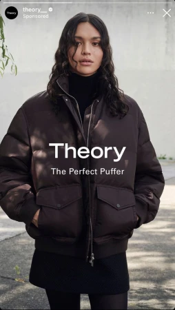 Portrait of a woman wearing a brown puffer jacket with dark hair, shot outdoors with visible text overlay.