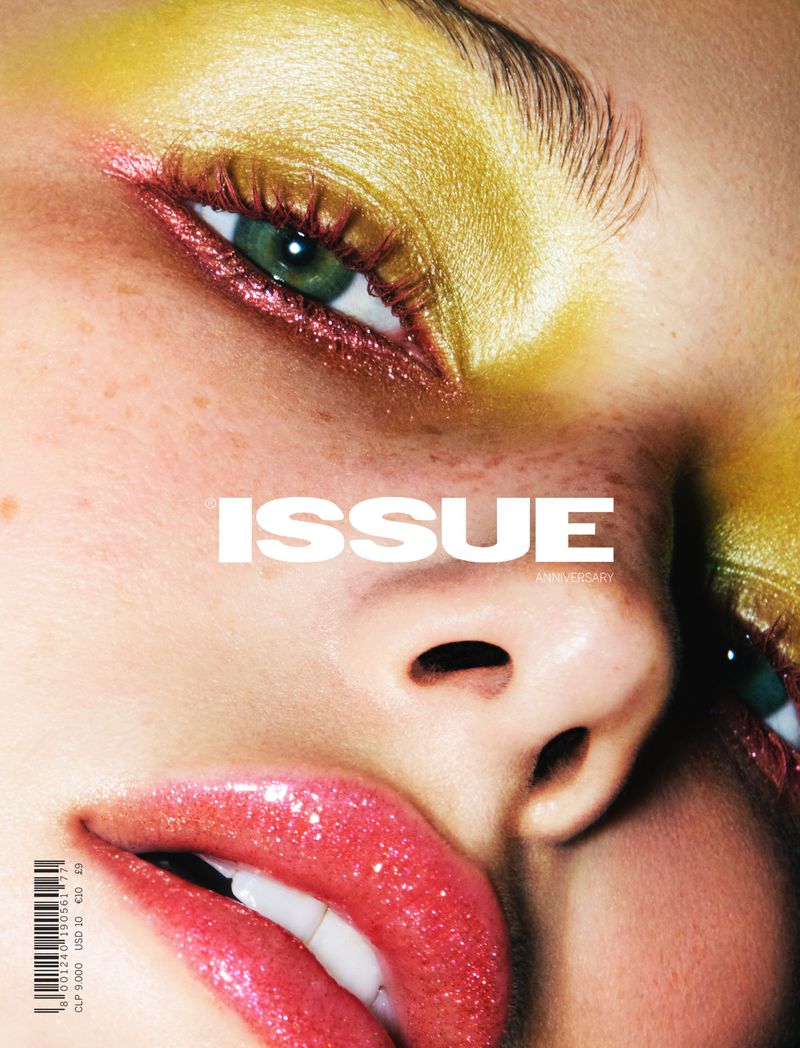 Close-up of a woman's face with yellow eyeshadow and glossy lips, featured on the cover of 'Issue' magazine, beauty and fashion.