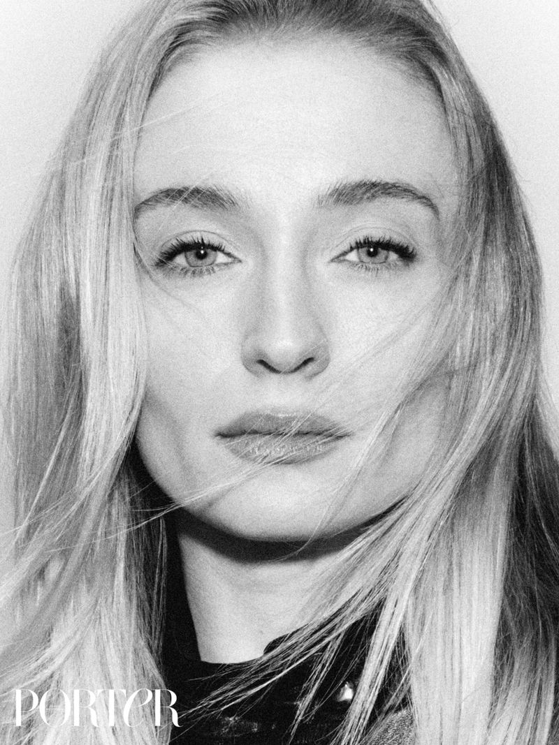 Black and white headshot of a blonde woman with fair skin, fair hair, and light eyes facing forward, set against a simple light backdrop.