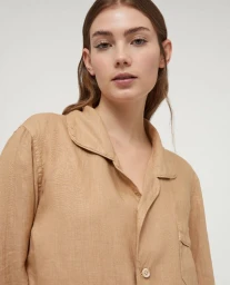 Model wearing a camel linen button-down shirt against a solid white background for the Aspesi Spring/Summer 2023 collection.