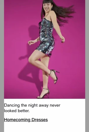 A slender Asian woman in a sparkly grey mini-dress and strappy heels poses in a dance position against a solid pink backdrop.