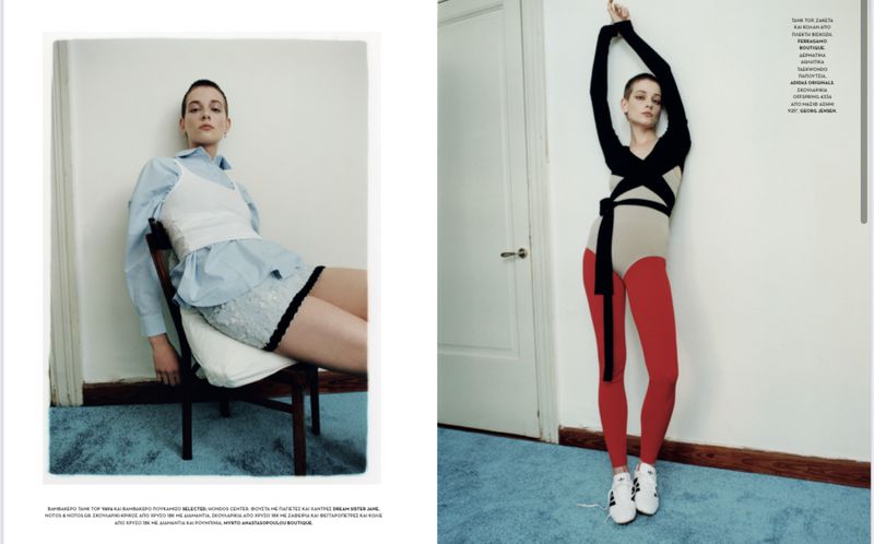 Editorial fashion shot: Two adult women pose indoors against a white wall in modern clothing, one seated, the other standing.