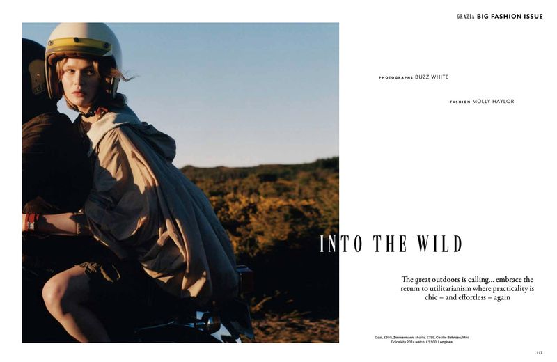 Editorial fashion shot featuring a young female model wearing a cream-colored motorcycle helmet and jacket, posing on a motorcycle outdoors.