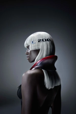 Striking beauty portrait of an adult woman with white hair, wearing a red collar, against a grey background, featuring 'C 200' text.