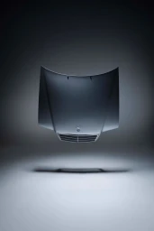 A dark car hood floating against a grey studio backdrop with a shadow cast below it.