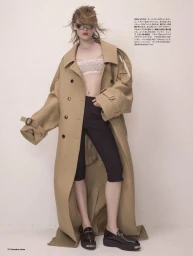 Model wearing a long beige trench coat, black capri pants, and sunglasses against a plain white studio background.
