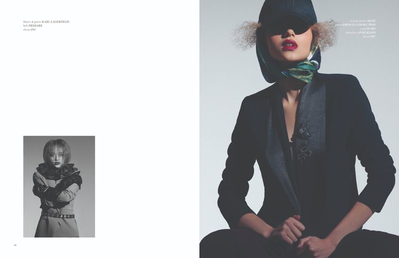 Fashion editorial shot of a woman in a black blazer, scarf, and baseball cap against a light grey background, with a black and white inset image.
