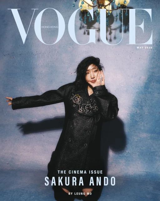 Vogue Hong Kong magazine cover featuring Sakura Ando, shot at eye-level, wearing a black coat against a textured blue background.