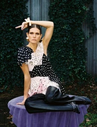 Model Malgosia Bela poses in a polka-dot top and black boots for Re-Edition Magazine photographed by Davit Giorgadze