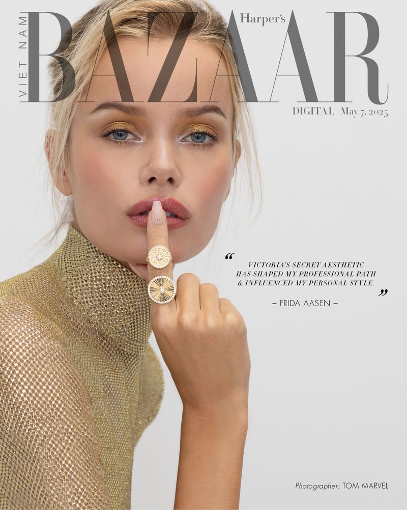 Harper's Bazaar cover featuring a blond adult female model with gold eye shadow wearing a gold turtle neck and two rings on her finger.