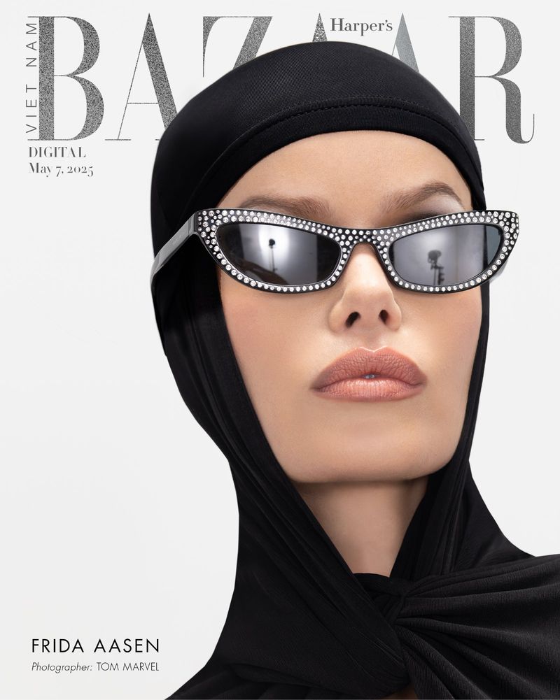 Close-up fashion magazine cover featuring a woman wearing sunglasses with rhinestones and a black head covering against a white background.