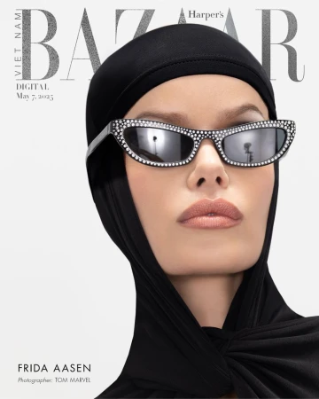 Close-up fashion magazine cover featuring a woman wearing sunglasses with rhinestones and a black head covering against a white background.