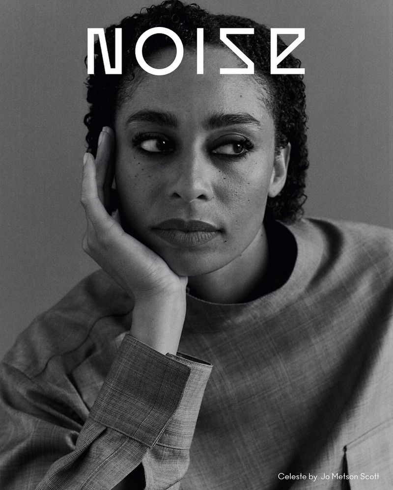 Black and white portrait of a woman with curly hair, wearing a gray shirt, with the text 'NOISE' above her head on a gray background.