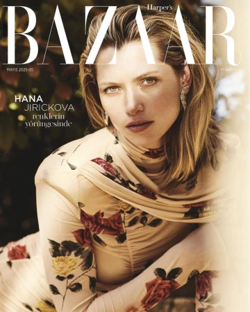 Fashion magazine cover featuring a blonde woman in a floral dress, posing for a portrait-style shot with 'BAZAAR' in bold text.