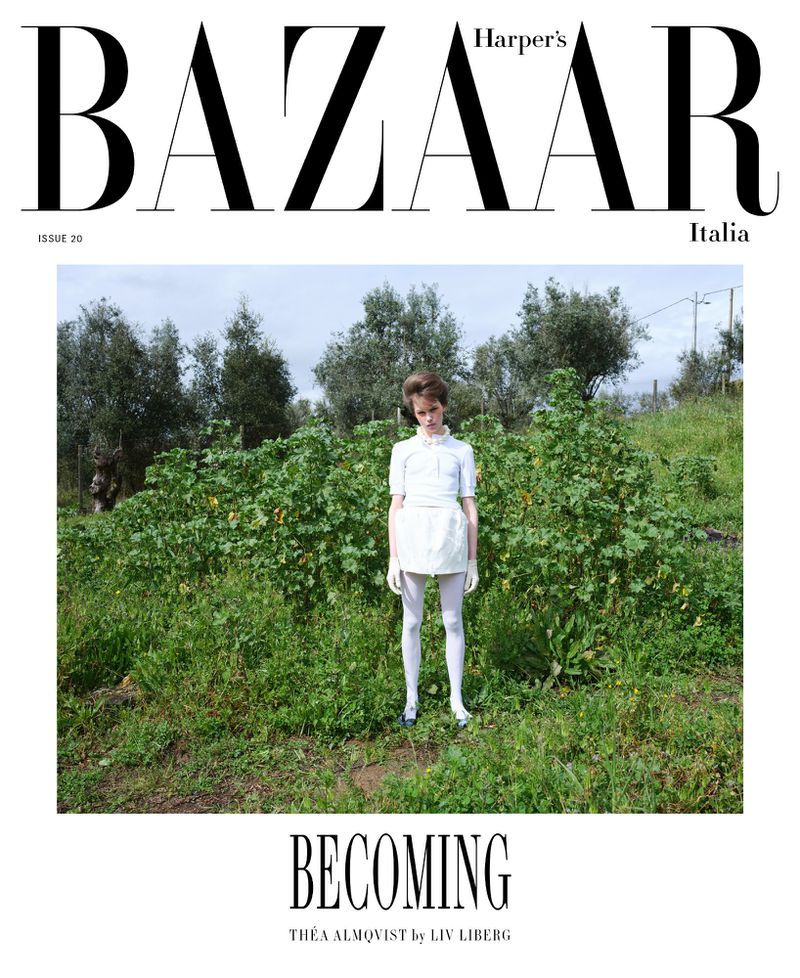 Fashion editorial cover for Harper's Bazaar Italia featuring a young female model in a white dress, white tights, and blue shoes in a grassy field.