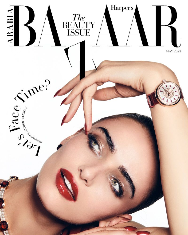 Harper's Bazaar Arabia cover featuring a woman with red lips and a wristwatch, emphasizing beauty and fashion. May 2025 issue.
