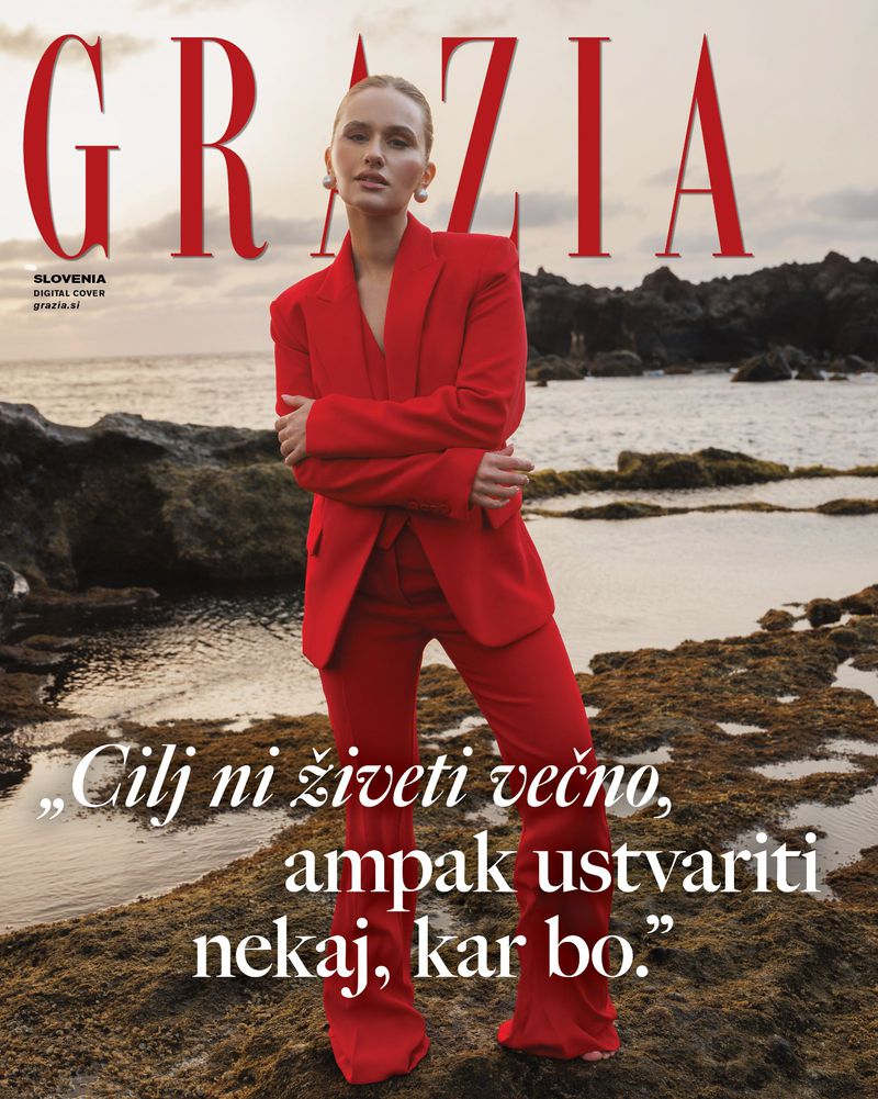 GRAZIA cover featuring a woman in a red suit posing against a rocky shoreline and ocean backdrop, under the magazine's logo and text.