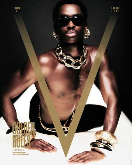 Shirtless Black man poses with gold jewelry against a dark background for V Magazine, Summer 2023 edition, highlighting style and fashion.