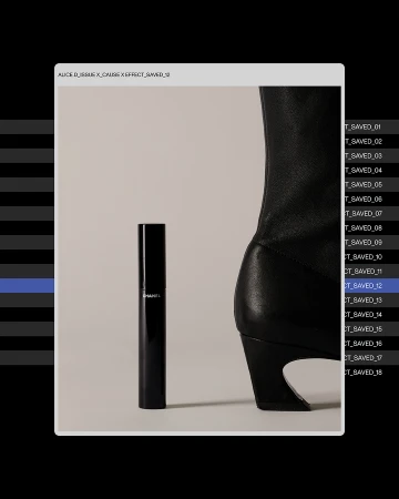 Studio shot of Chanel mascara with black leather heeled boot against a cream backdrop, product photography for beauty and fashion industries.