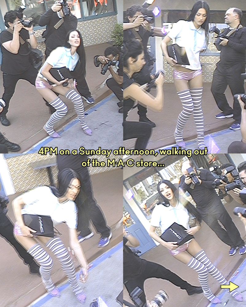 Fashion photo shoot: model poses outside MAC store surrounded by paparazzi, wearing pink shorts, thigh-high socks, and a light blue shirt.