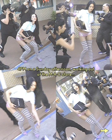 Fashion photo shoot: model poses outside MAC store surrounded by paparazzi, wearing pink shorts, thigh-high socks, and a light blue shirt.