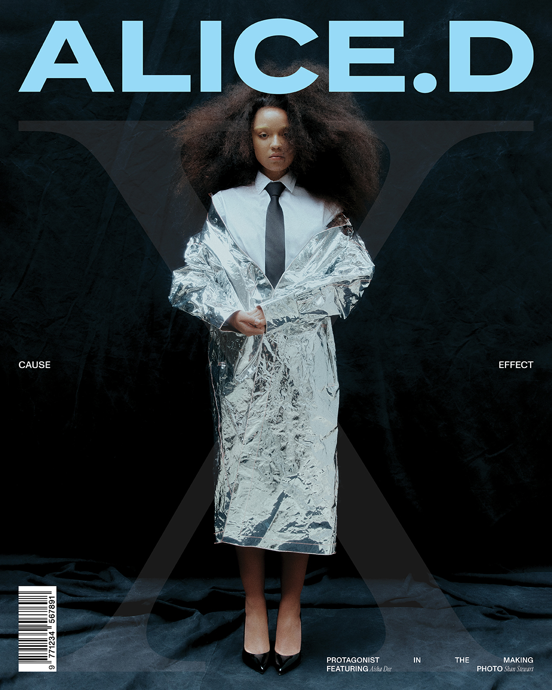 Magazine cover featuring a woman with voluminous hair in a metallic silver coat, black tie, and heels against a black background.