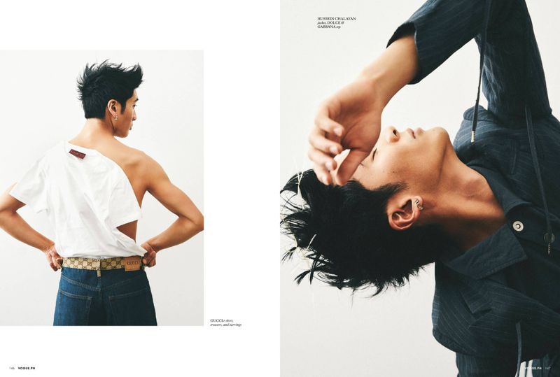 Editorial fashion shot: an Asian male poses in jeans and a jacket against a white backdrop in a studio setting with bright lighting.