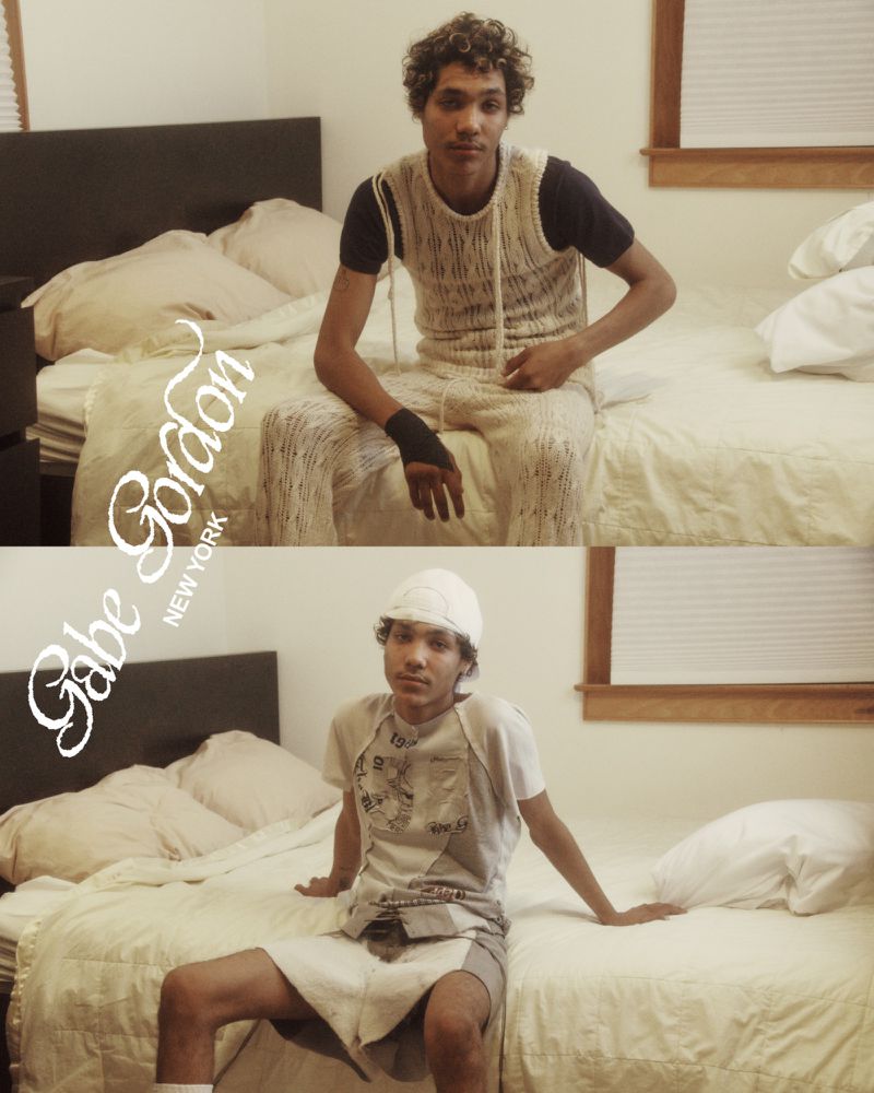 Portrait of a young adult man wearing a knitted outfit in two split-screen shots in a bedroom setting with a bed and window.