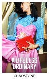 Woman wearing blue checkered shirt, pink gown, and holding red clutch in a retail campaign for Chadstone.