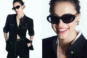 Margaret Qualley wearing black sunglasses and a tweed jacket in the Chanel Eyewear campaign