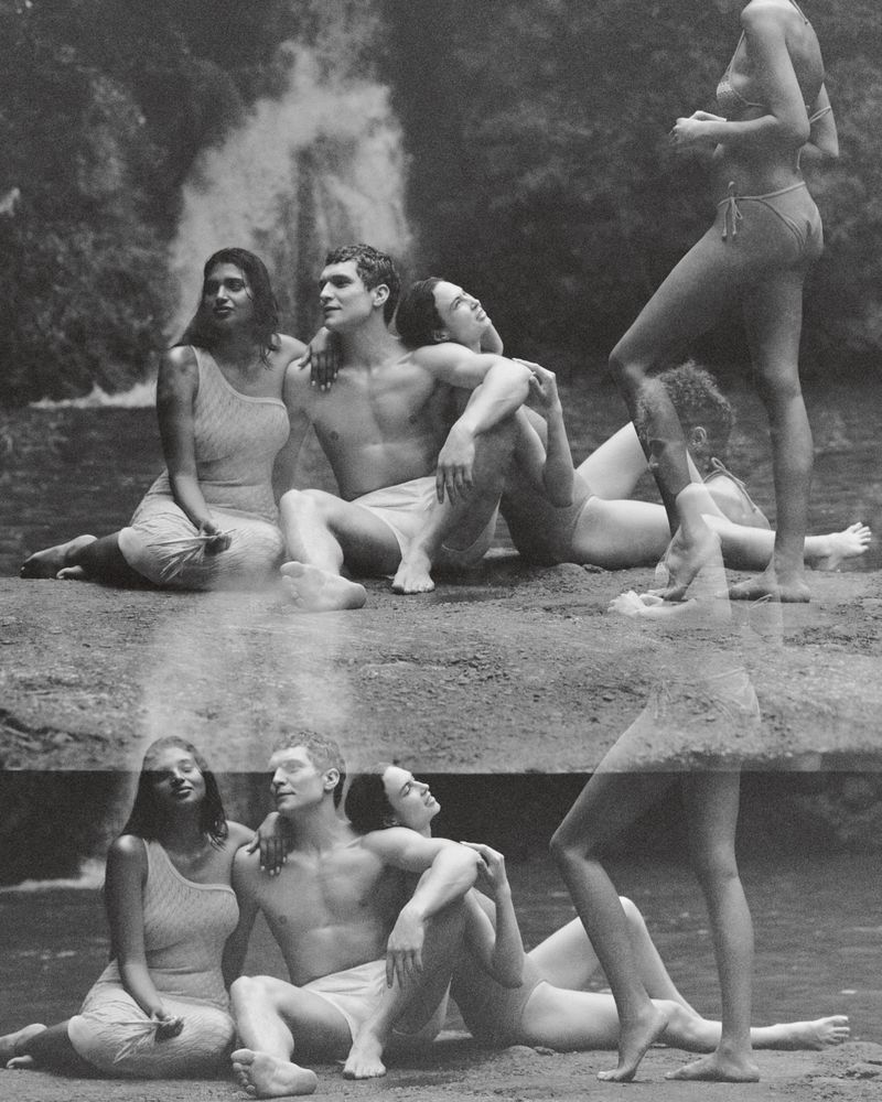 Monochrome image featuring a group of four people sitting and standing near a waterfall with double exposure creating a surreal effect.