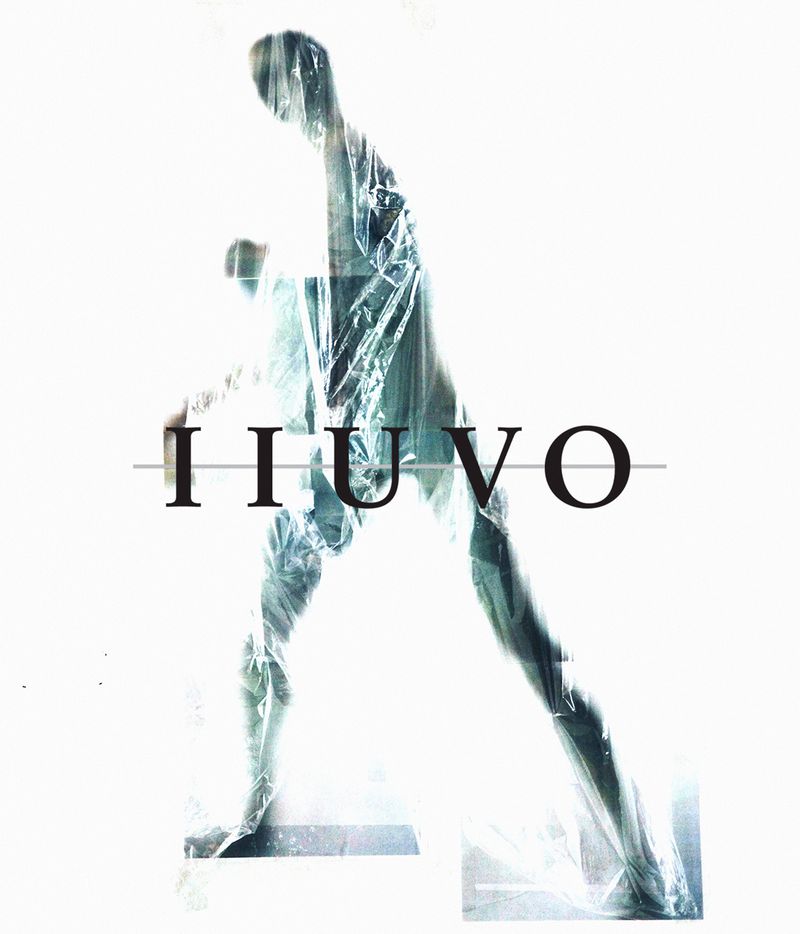 Abstract fashion shot: Figure draped in plastic stands in a bright, minimalist setting with bold sans-serif brand typography.