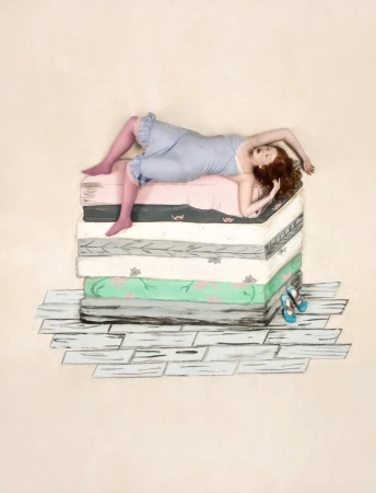 A woman with red hair lies atop a stack of mattresses, wearing a vintage-style negligee and stockings, with shoes on a painted floor.