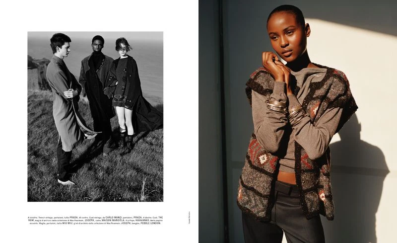 Fashion editorial shot of an African woman in patterned vest posing indoors with a group of models in black and white landscape.