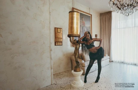 Jodie Turner-Smith posing beside a classical sculpture in a luxury hotel interior for Re-Edition Magazine