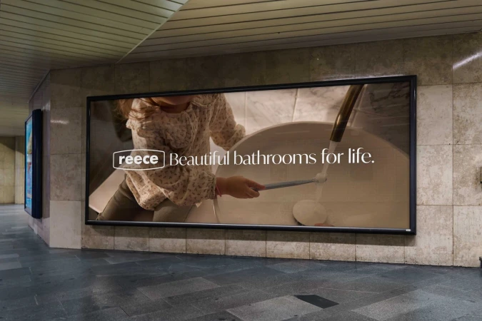 Reece ad in subway shows a child by a bathroom sink with the tagline: Beautiful bathrooms for life. The ad is set in a subway.