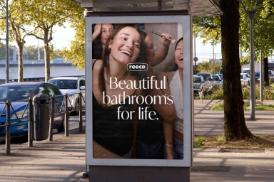 Reece outdoor advertising poster on a city street showing a group of smiling young women
