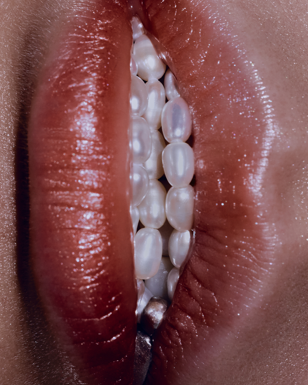 Close-up studio shot of red lips slightly open, filled with lustrous white pearls. Focus on beauty and luxury, highlighting detail.