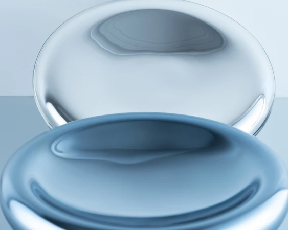 Abstract image with two translucent blue spheres, one clear and one opaque, creating a visually interesting studio art composition.