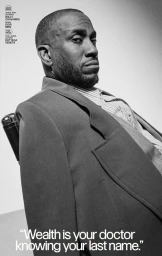 Portrait of artist Rashid Johnson wearing a structured suit jacket and striped shirt, shot in black and white for Interview Magazine.