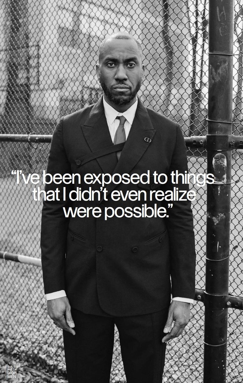 Portrait of a Black man wearing a black double-breasted suit standing in front of a chain-link fence with overlaid text.