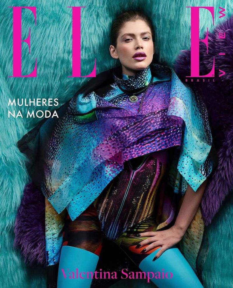 Elle Brazil magazine cover featuring Valentina Sampaio wearing a patterned outfit with bright blue tights, posing against a textured background.
