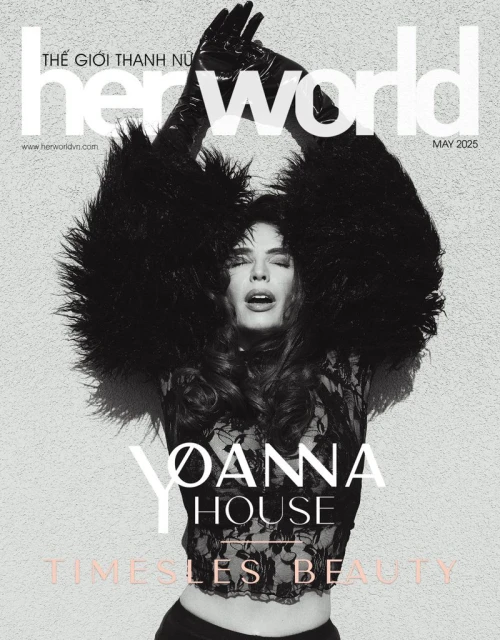 Her World magazine cover featuring a woman with dark hair, wearing black gloves and lace top, with feathered accents. May 2025 issue.