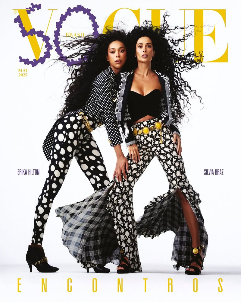 Two women grace a Vogue Brasil cover in retro-inspired black and white outfits, showcasing bold patterns and voluminous curly hair.