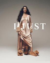 Woman in satin robe and matching slippers standing beside a dachshund for Peter Alexander